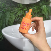 Hand holding a Bring Your Fire Facial Oil by HotChi