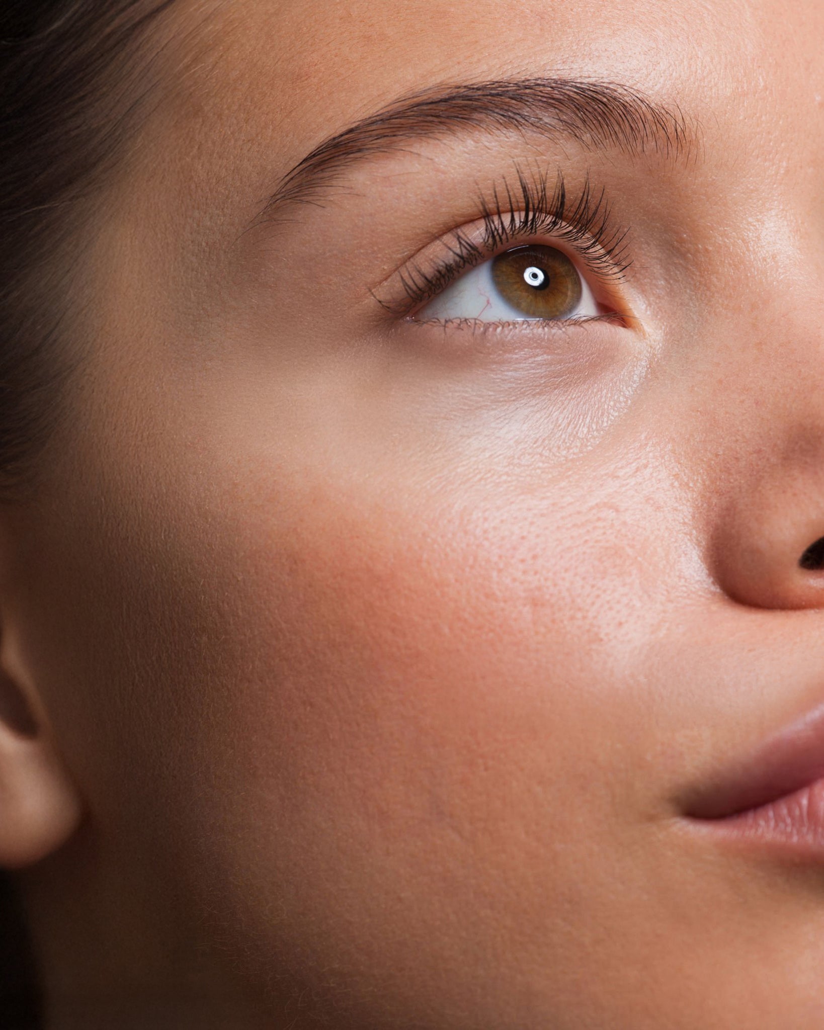 Close-up of a woman’s skin texture, showcasing natural pores, fine lines, and healthy complexion in high detail.