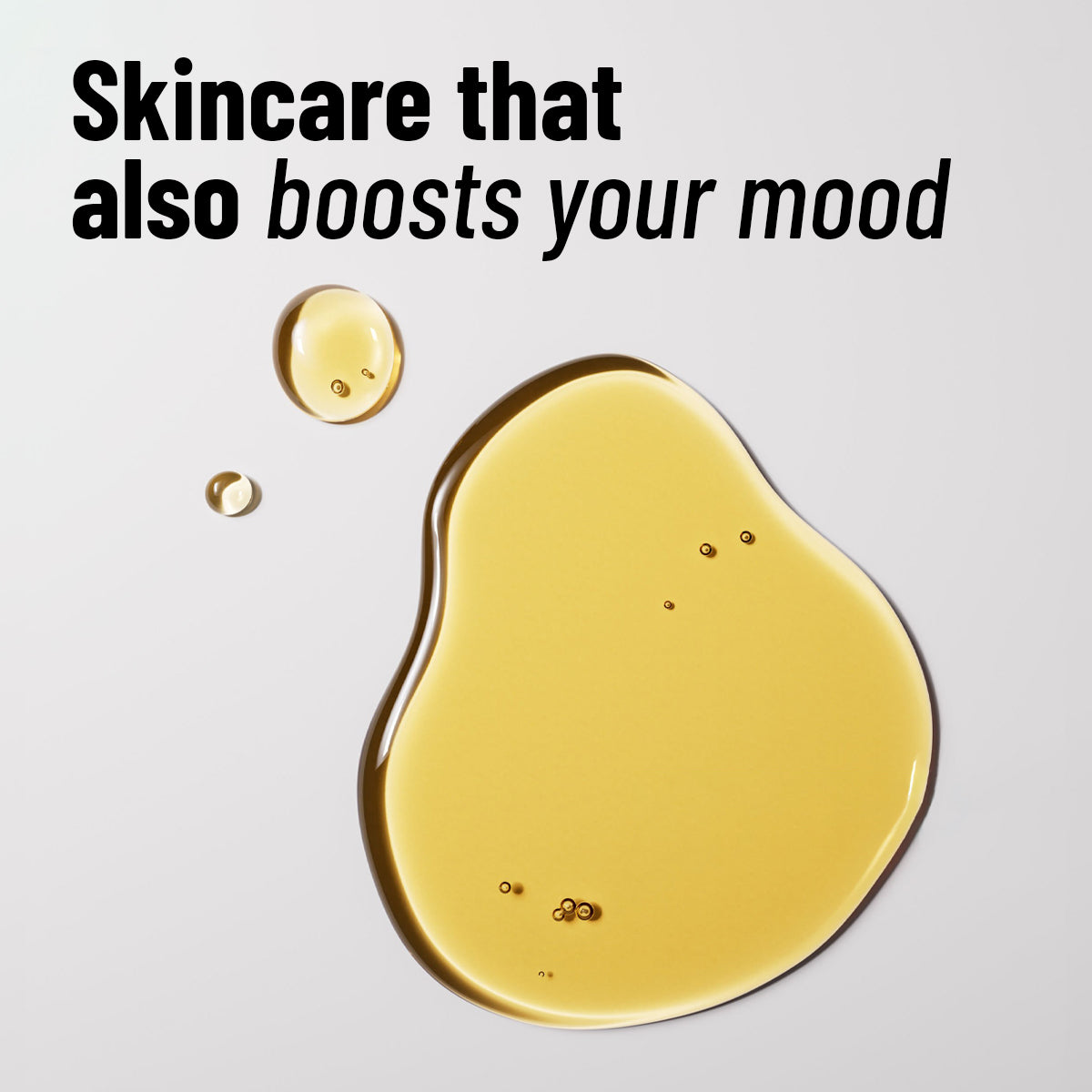 White background image with golden facial oil drops and text saying ‘Skincare that also boosts your mood.