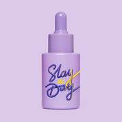 Studio image of HotChi’s Slay All Day Facial Oil bottle set against a bold purple background, reflecting its empowering and emotionally strengthening properties.