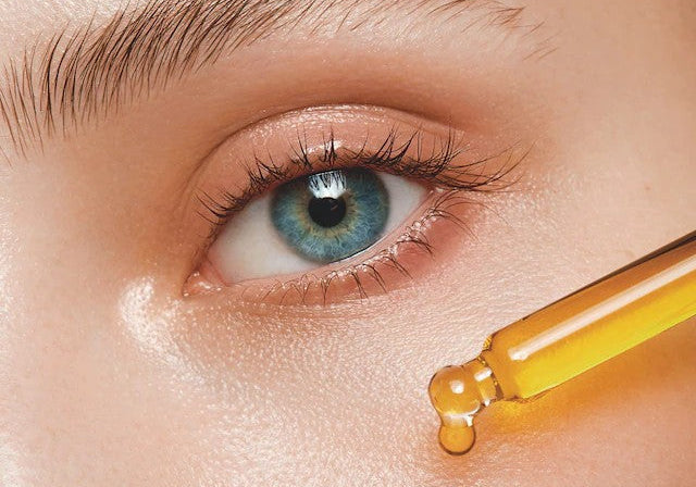 Woman Applying Peptides on her Face Close Up