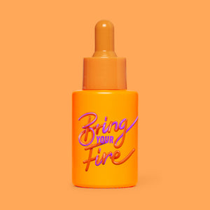 Studio photograph of HotChi’s Bring Your Fire Facial Oil on orange background, symbolising calming, soothing benefits.