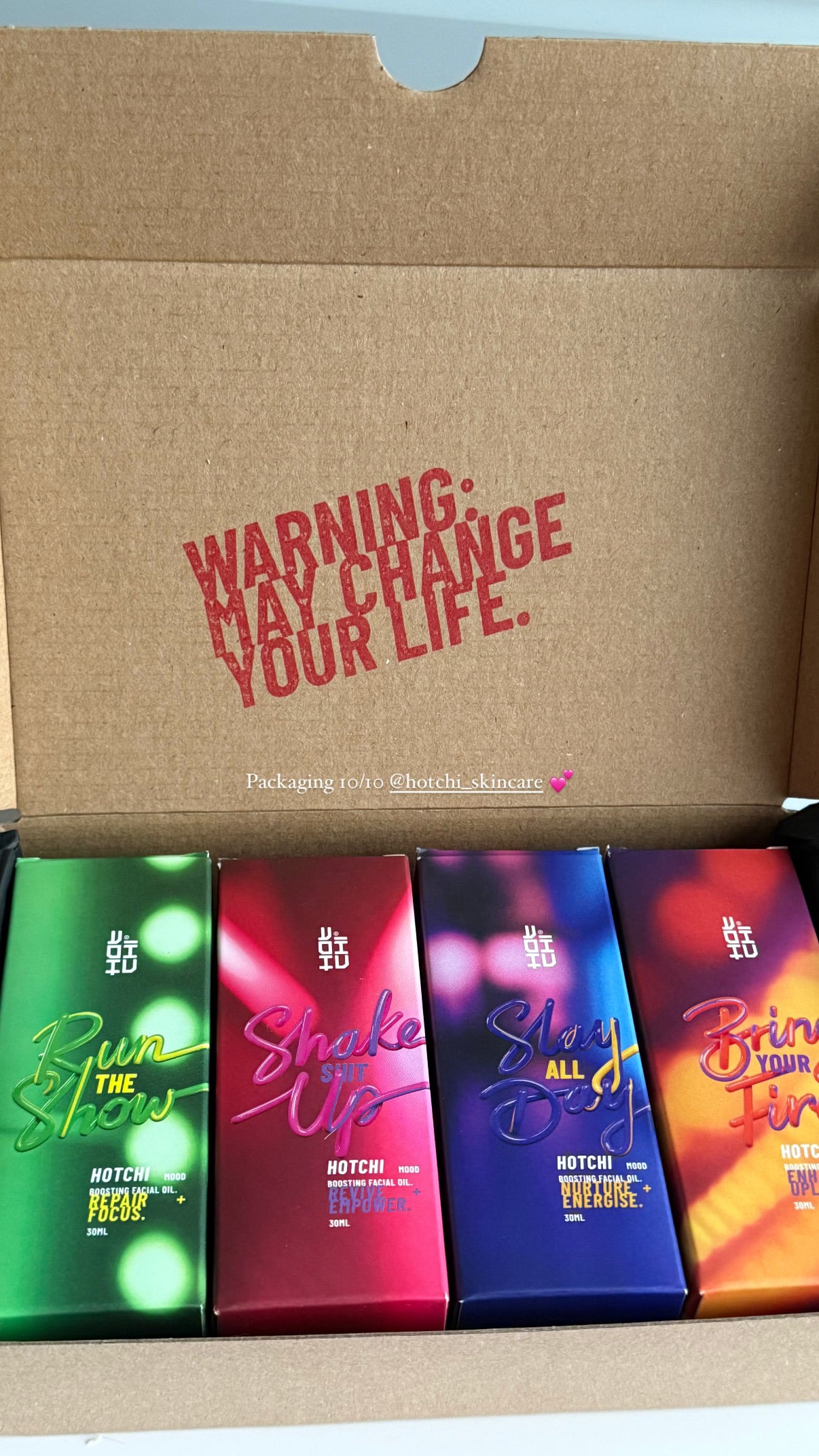 All four HotChi skincare products displayed together inside a gift box