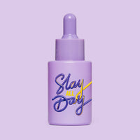 Studio image of HotChi’s Slay All Day Facial Oil on purple background, highlighting empowering, confidence-boosting benefits.