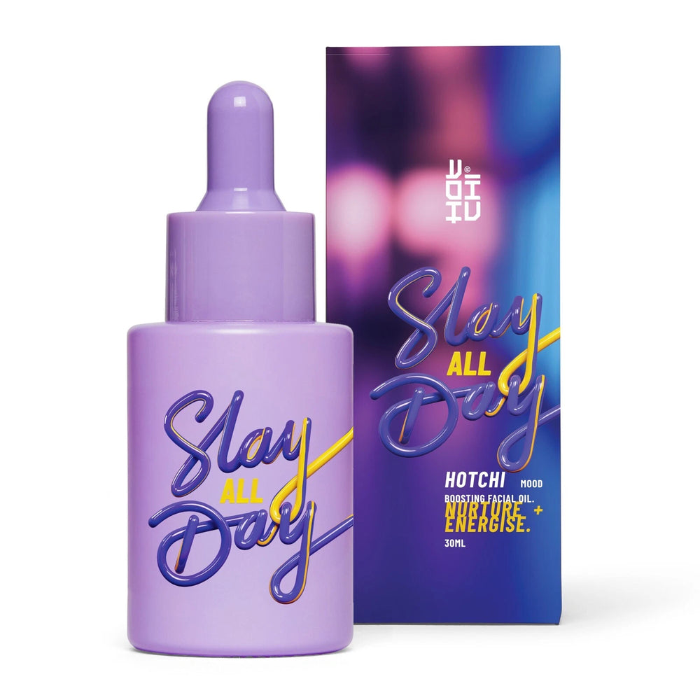Slay All Day Facial Oil with product box – purple bottle with dropper, made to support emotional strength and reduce flare-ups, styled next to its matching purple packaging.