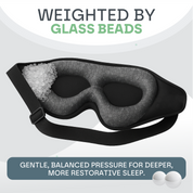 Black sleep mask with glass beads on a light gray background