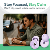 Man using a laptop with purple earplugs on a blurred street background, featuring text 'Stay Focused, Stay Calm'.