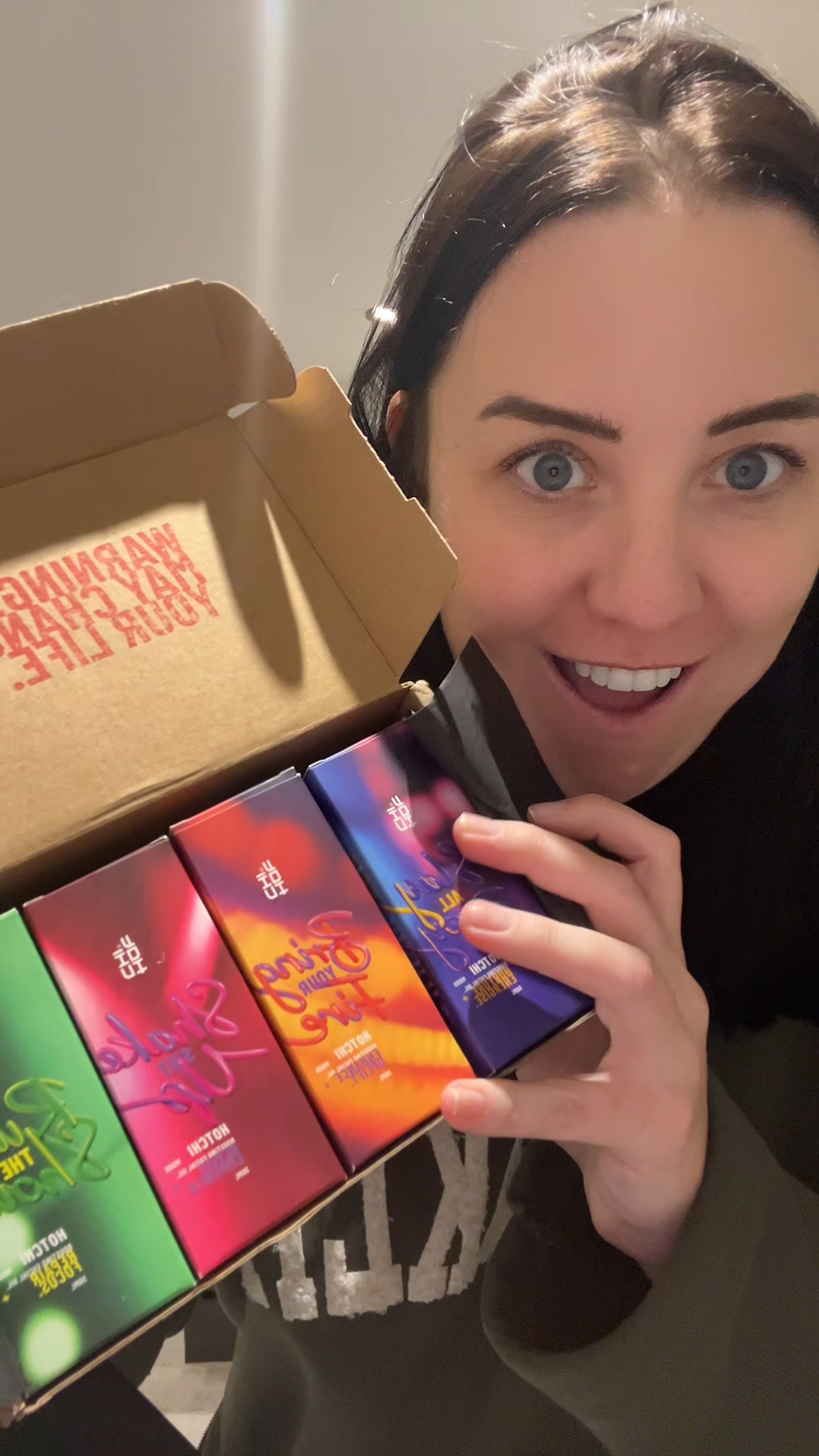 Different woman holding all HotChi skincare products together